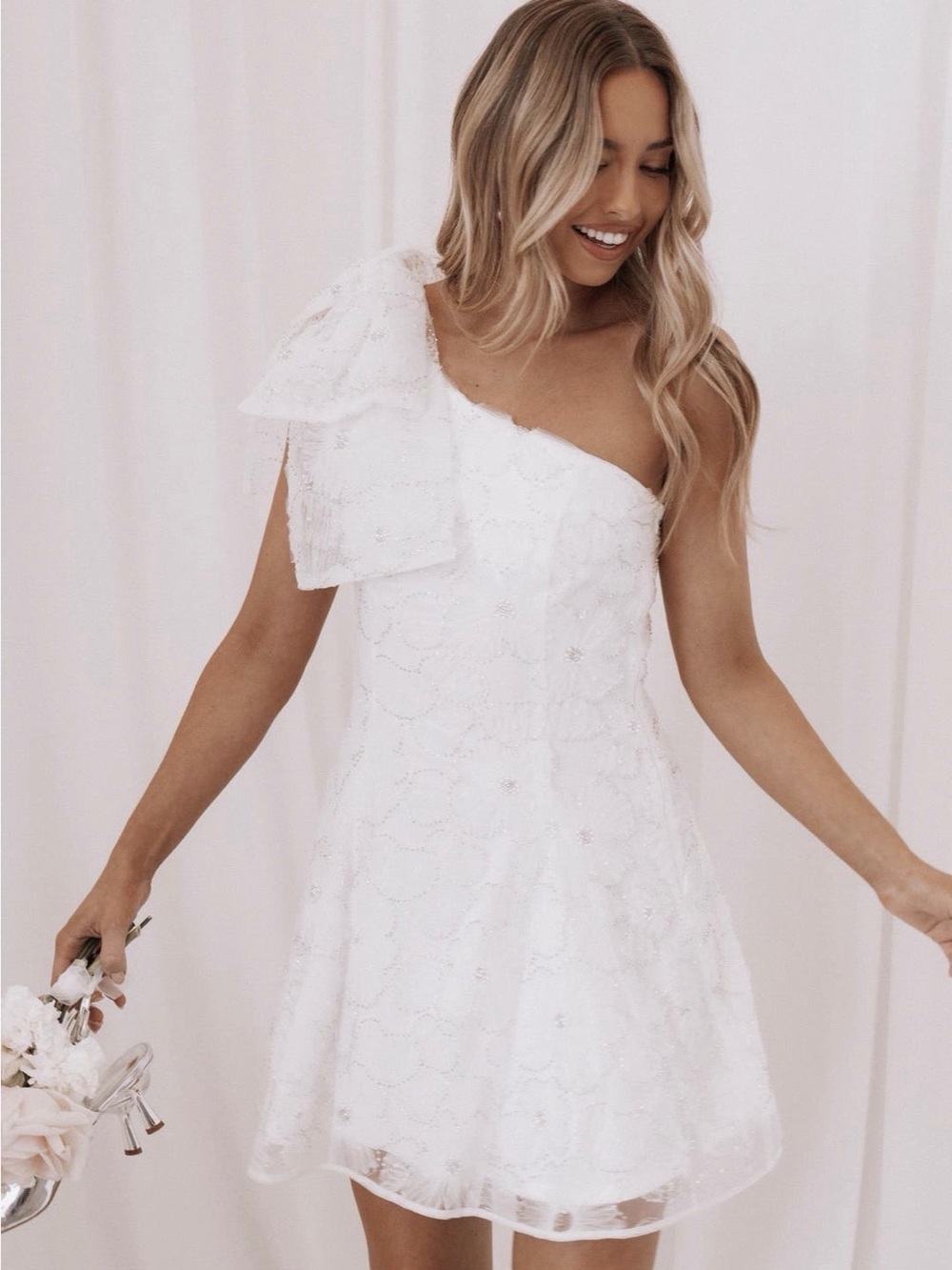 White Lace embellished Mini Dress with one sleeve bow